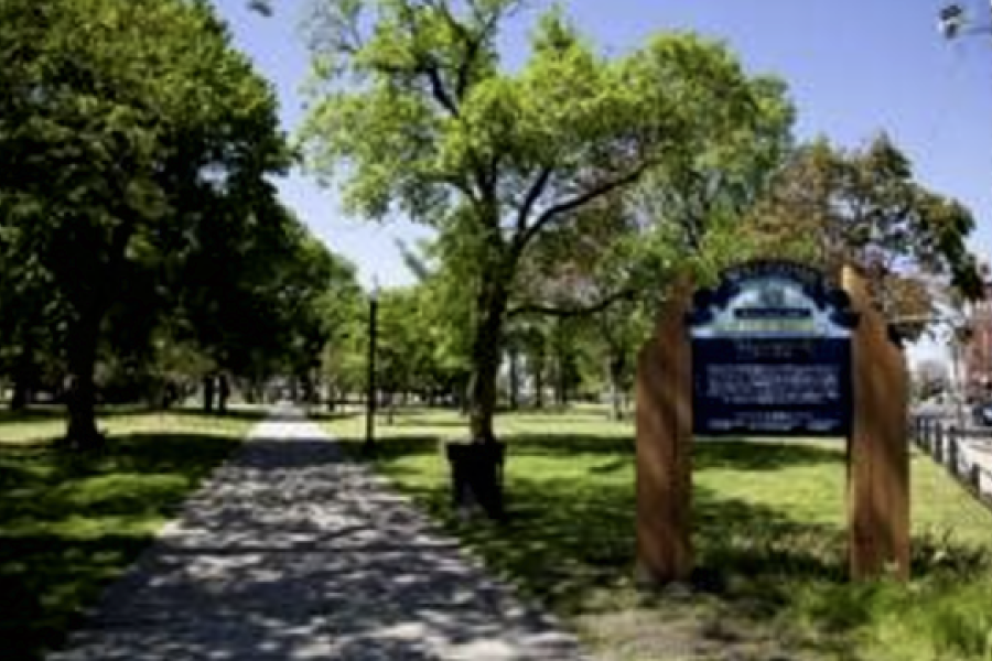 Public park with trees, paths, and "Welcome" sign