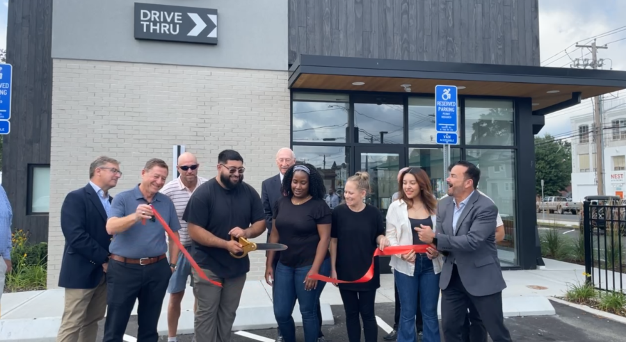 Photo of Mayor Ganim, Starbucks Staff, and Starbucks owner Richard Koris, cutting a red ribbon during the grand opening ceremony for the 1705 Fairfield Ave location of Starbucks